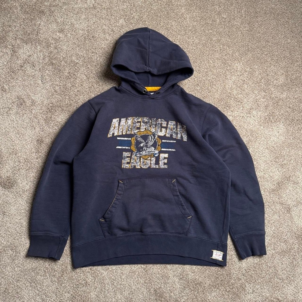 NAVY AMERICAN EAGLE VARSITY CRACKED GRAPHIC PULLOVER HOODIE